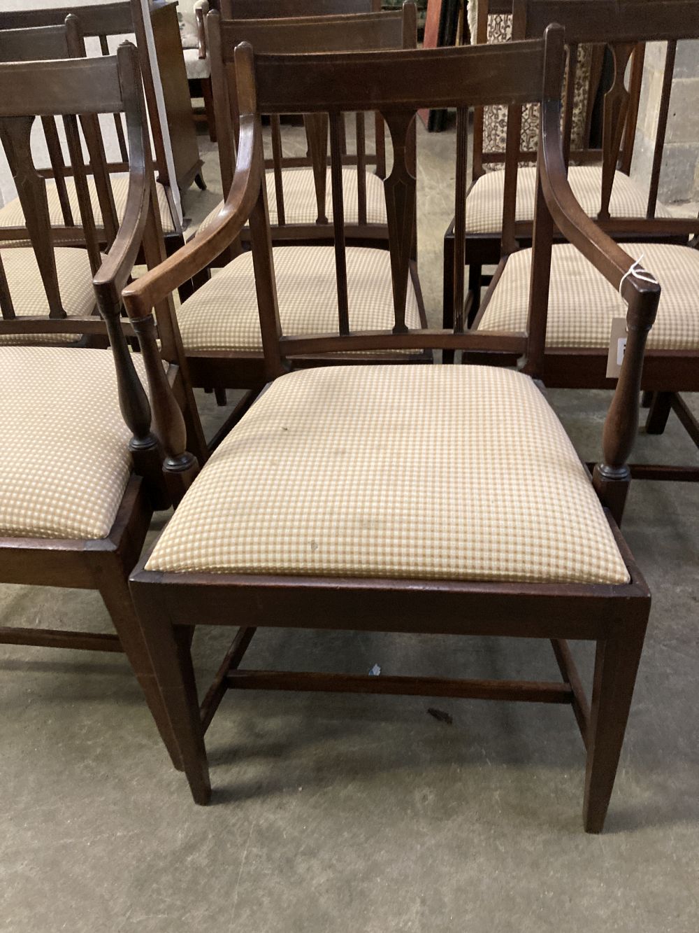 A set of eight late George III mahogany dining chairs, two with arms, six single
